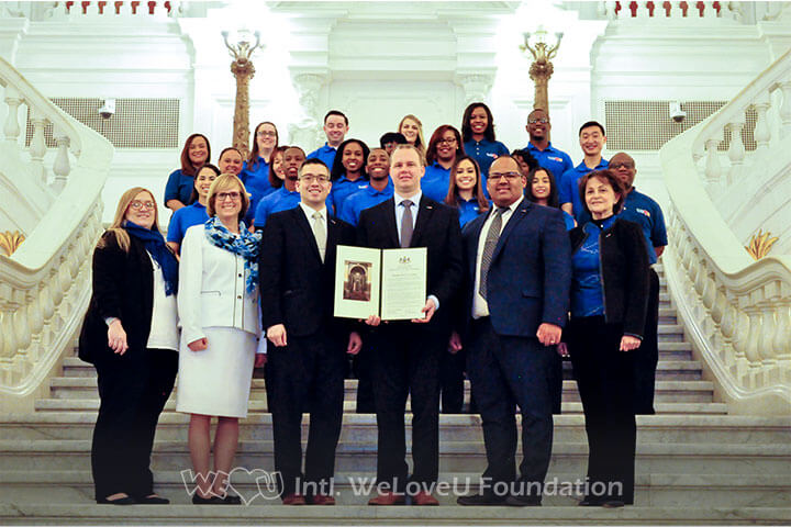 WeLoveU Foundation representatives and volunteers take a group photo with the Citation