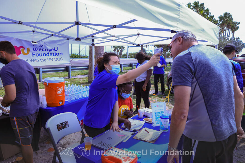 A volunteer is checking a participant's temperature