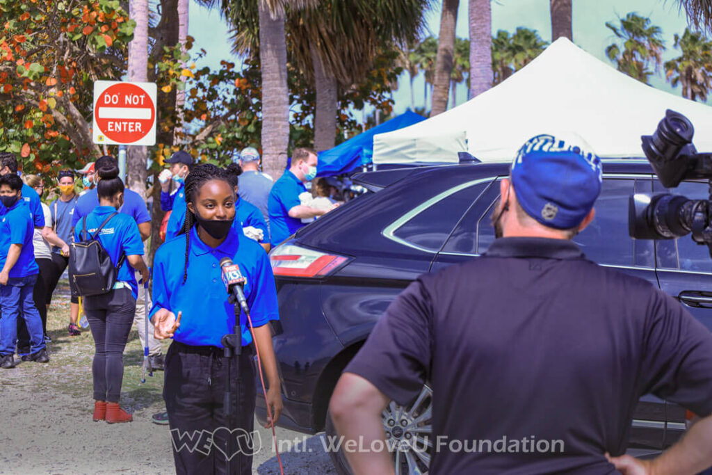 A WeLoveU volunteer gives an interview to Fox 13 News
