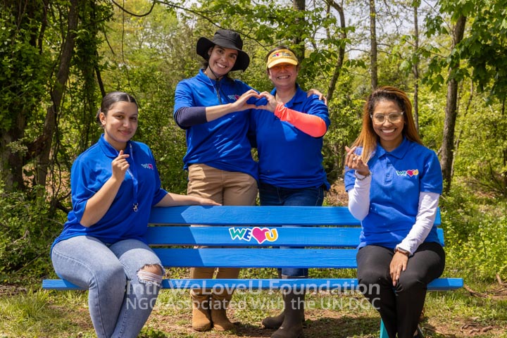 Volunteers sitting on the newly painted bench