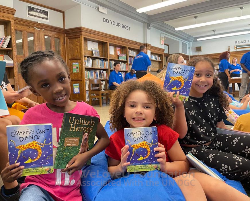 Students holding up books