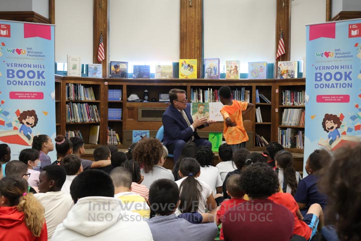 Senator Moore reading a book to students