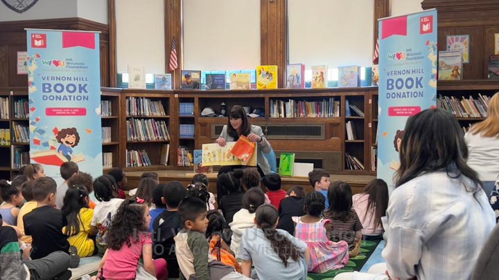 Senator Flynn reading a book to students