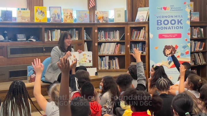Senator Flynn reading a book to students