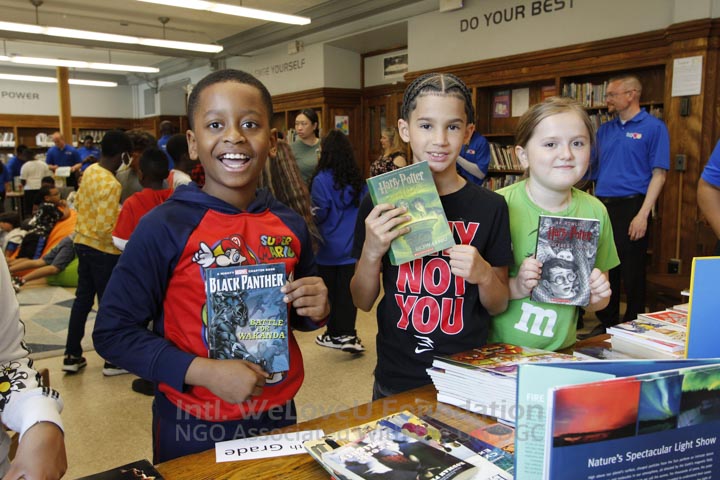 Students holding up books